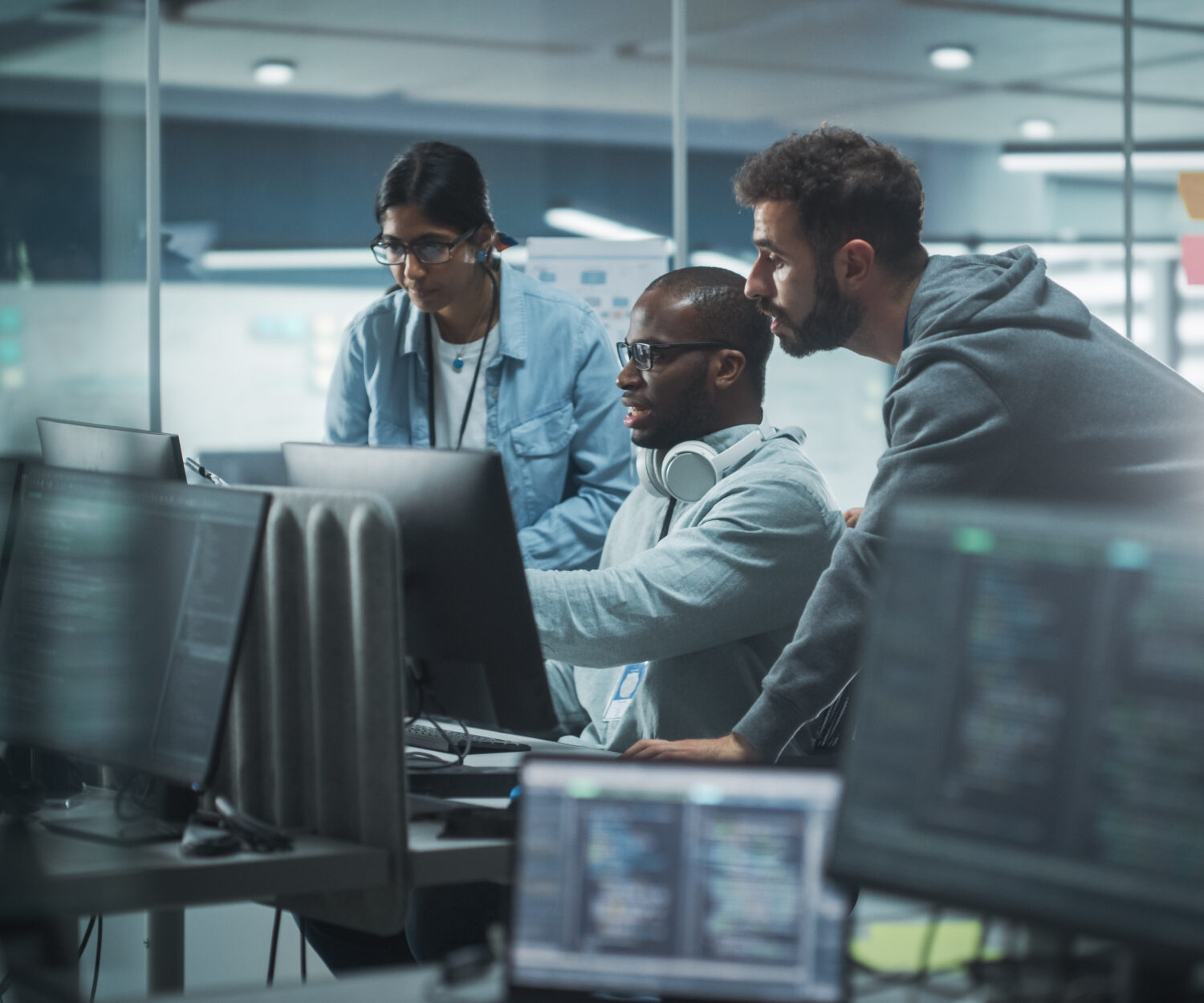 Diverse Group of Professionals Meeting in Modern Office: Brainstorming IT Programmers Use Computer Together, Talk Strategy, Discuss Planning. Software Engineers Develop Inspirational App Program